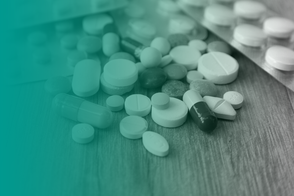 A selection of prescription medications, pills and tablets on a table.